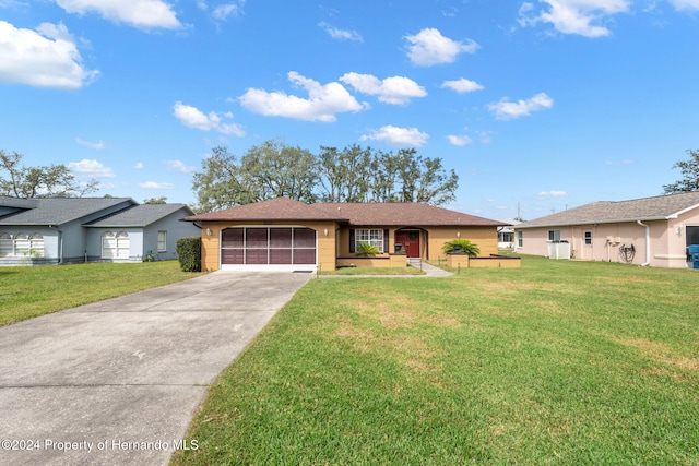 ranch-style home featuring a front lawn and a garage