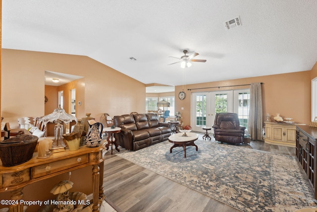 8227 Rhanbuoy Rd, Spring Hill, FL 34606 - living room featuring wood finished floors, a ceiling fan, lofted ceiling, and a textured ceiling