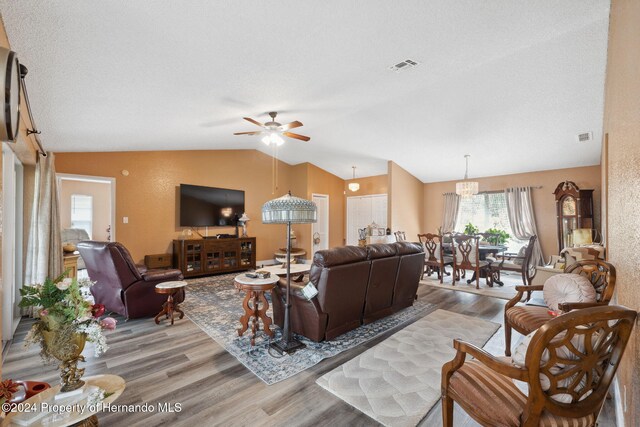8227 Rhanbuoy Rd, Spring Hill, FL 34606 - living room featuring wood finished floors, lofted ceiling, and ceiling fan