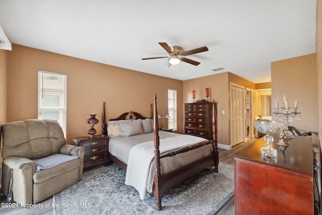 8227 Rhanbuoy Rd, Spring Hill, FL 34606 - bedroom with a ceiling fan, a closet, and a textured ceiling