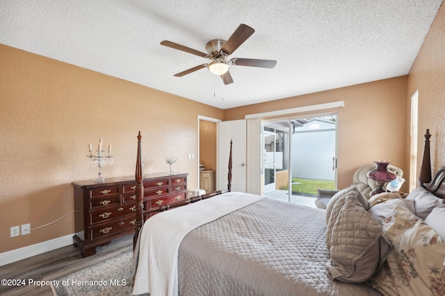 8227 Rhanbuoy Rd, Spring Hill, FL 34606 - bedroom featuring access to outside, wood finished floors, a textured wall, a textured ceiling, and ceiling fan