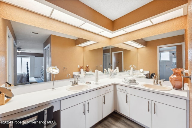 8227 Rhanbuoy Rd, Spring Hill, FL 34606 - ensuite bathroom with double vanity, wood finished floors, ceiling fan, and a shower with door