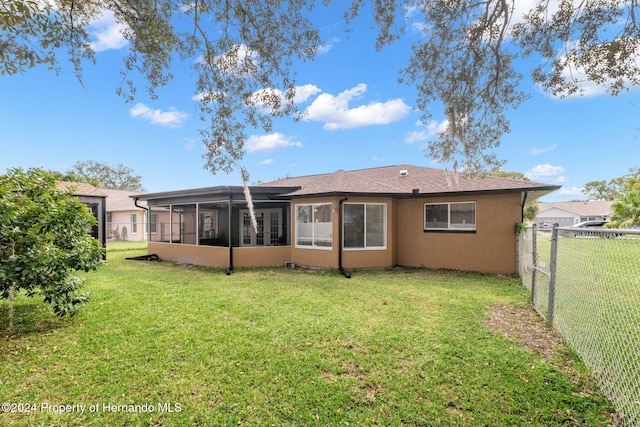 8227 Rhanbuoy Rd, Spring Hill, FL 34606 - back of property featuring a sunroom and a fenced backyard