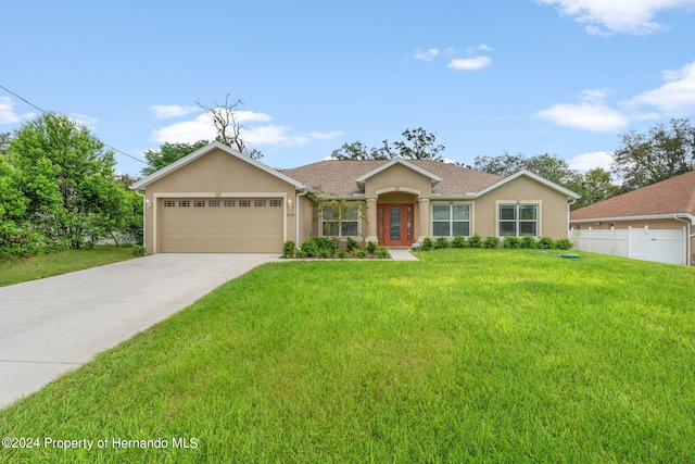 ranch-style house with a garage and a front lawn