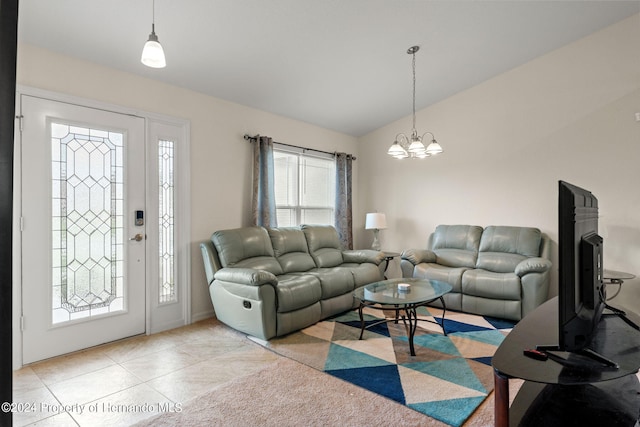 living room featuring a chandelier, vaulted ceiling, and light tile patterned floors