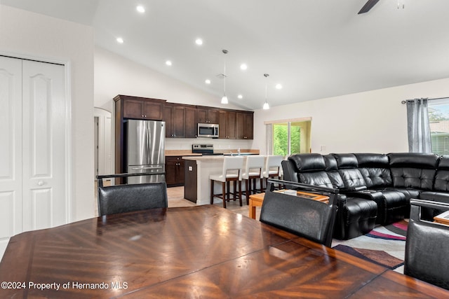 living room with high vaulted ceiling, plenty of natural light, and ceiling fan