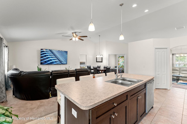 kitchen with lofted ceiling, dishwasher, sink, a kitchen island with sink, and ceiling fan