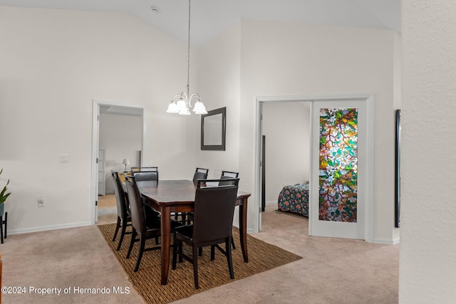 dining room featuring high vaulted ceiling, light carpet, and a notable chandelier