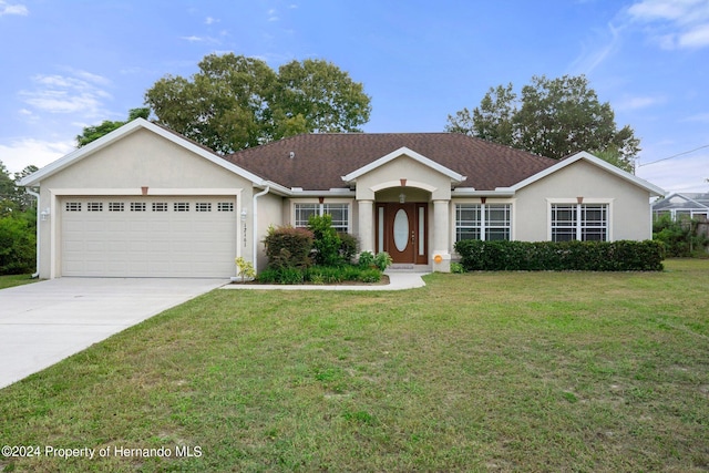 ranch-style home featuring a garage and a front yard