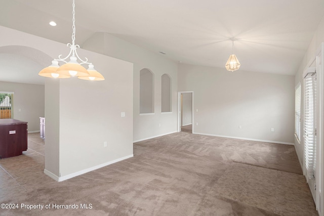 unfurnished room featuring lofted ceiling and carpet floors