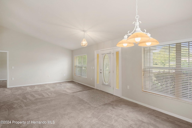 unfurnished room with lofted ceiling and carpet