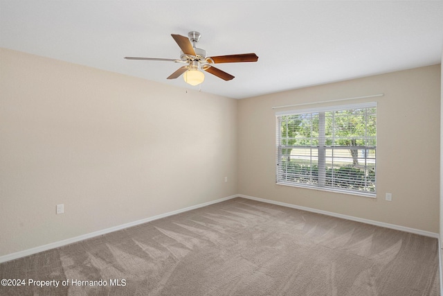 12161 Cavern Rd, Spring Hill, FL 34609 - empty room featuring light carpet and a ceiling fan