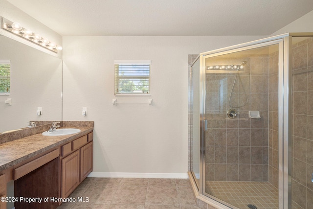 bathroom with vanity, walk in shower, and tile patterned flooring