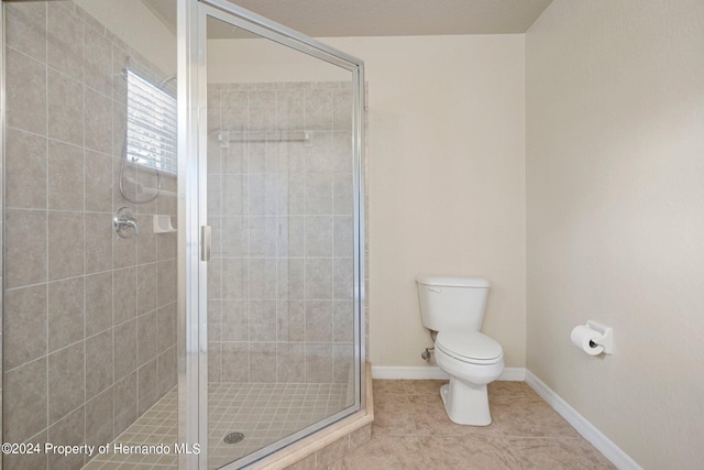 bathroom with walk in shower, tile patterned floors, and toilet