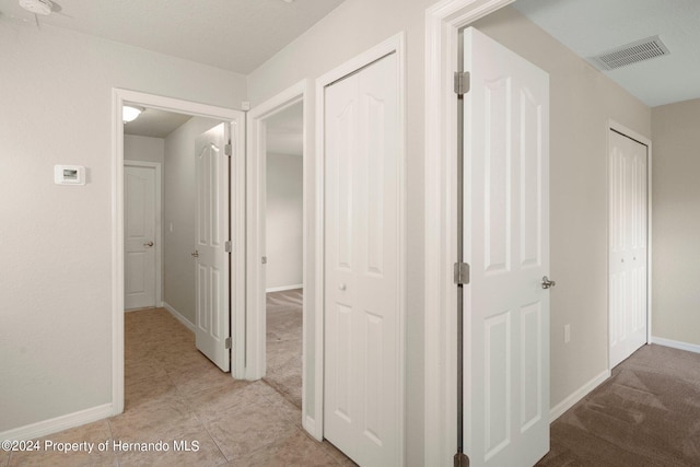 12161 Cavern Rd, Spring Hill, FL 34609 - hallway featuring baseboards and light tile patterned floors