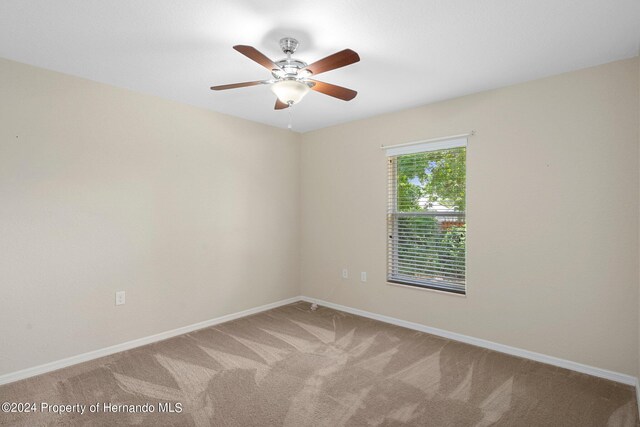 empty room featuring ceiling fan and carpet flooring