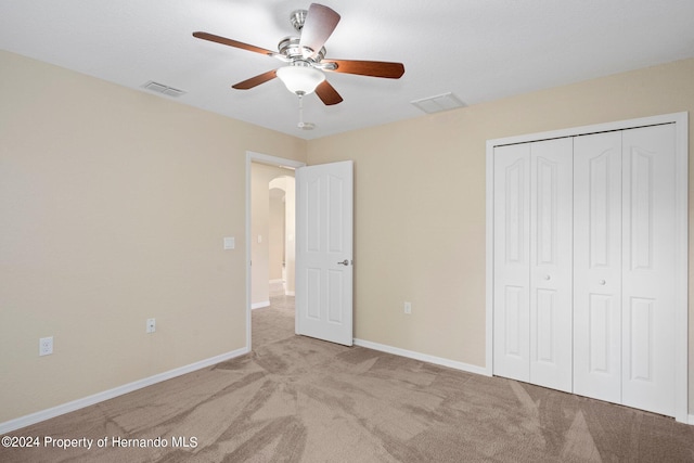 12161 Cavern Rd, Spring Hill, FL 34609 - unfurnished bedroom with arched walkways, carpet floors, a closet, and ceiling fan