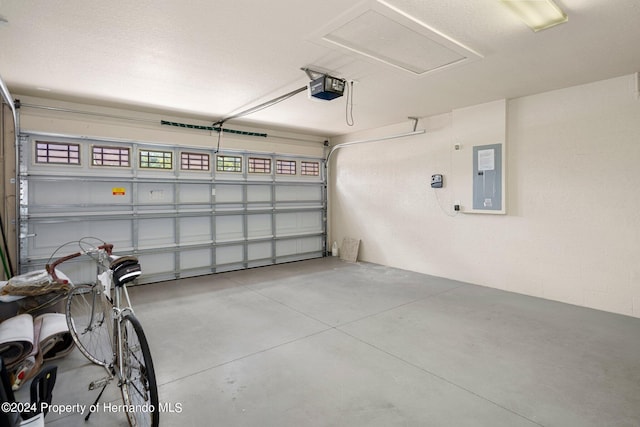 garage featuring electric panel and a garage door opener