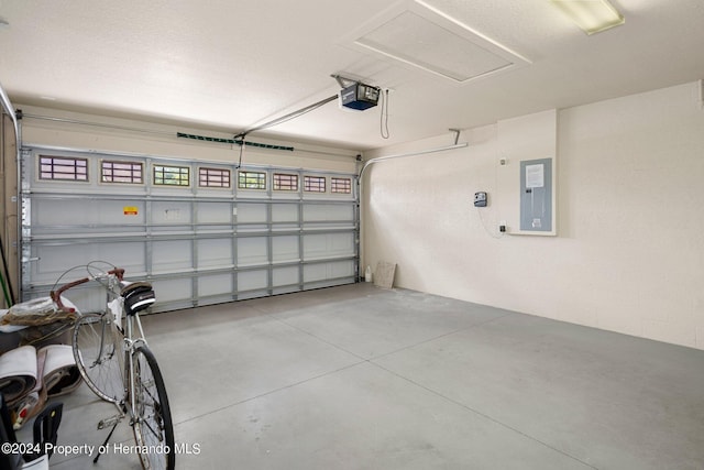 12161 Cavern Rd, Spring Hill, FL 34609 - garage featuring a garage door opener and electric panel