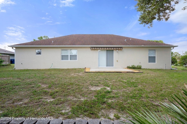 12161 Cavern Rd, Spring Hill, FL 34609 - rear view of house with a patio area, stucco siding, and a yard