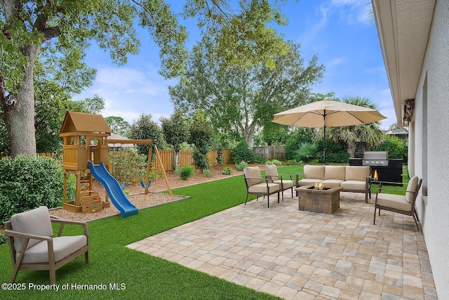 12161 Cavern Rd, Spring Hill, FL 34609 - fenced backyard with an outdoor living space with a fire pit, a patio area, a playground, and grilling area