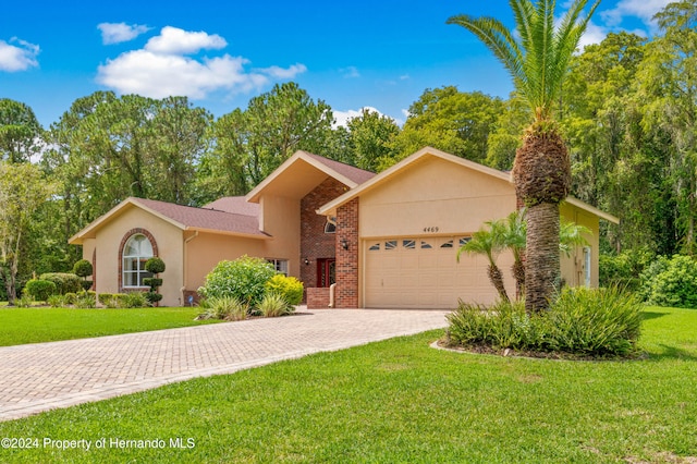 view of front of property featuring a garage and a front yard