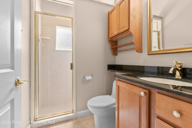 bathroom featuring walk in shower, vanity, tile patterned floors, and toilet