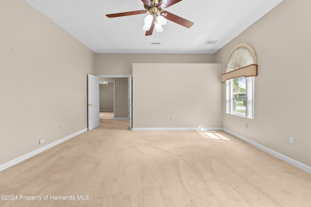 empty room featuring light carpet and ceiling fan