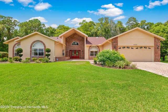 view of front of house with a garage and a front yard