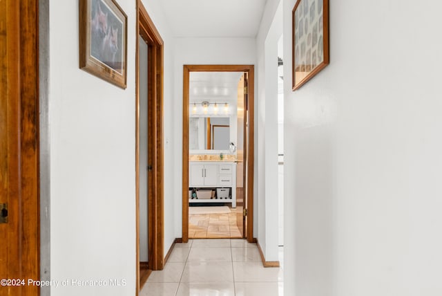 hall featuring light tile patterned floors