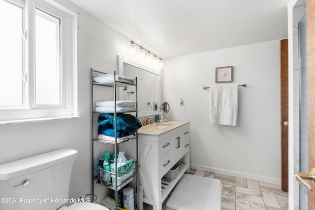 bathroom featuring toilet and vanity