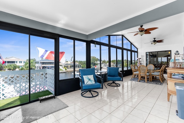 sunroom / solarium featuring a water view, a healthy amount of sunlight, and ceiling fan