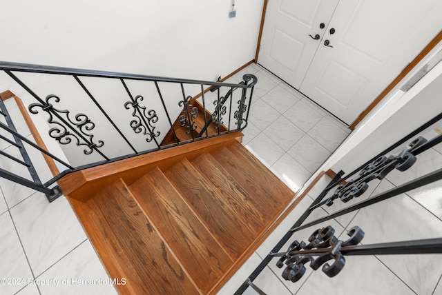 staircase featuring tile patterned floors