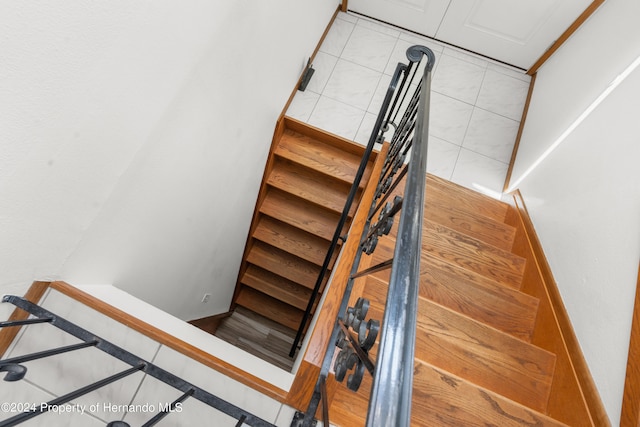 stairway with tile patterned floors