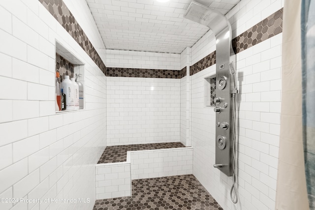 bathroom with tile walls and a tile shower