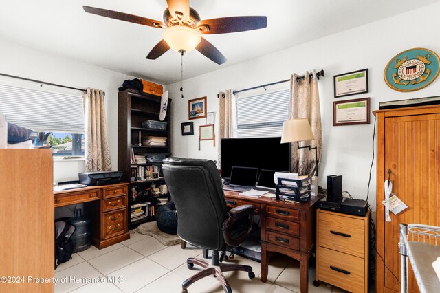 tiled office featuring ceiling fan