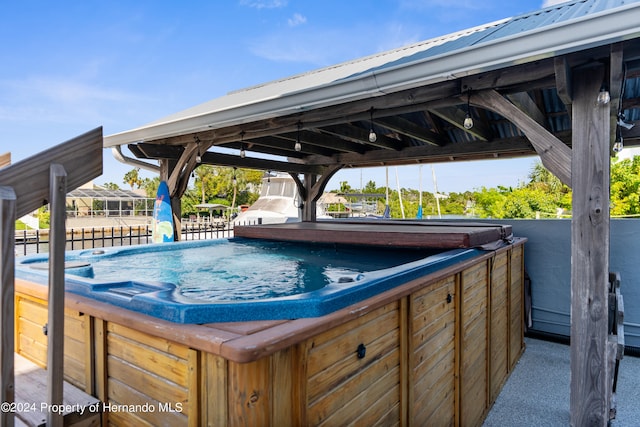 view of swimming pool featuring a hot tub