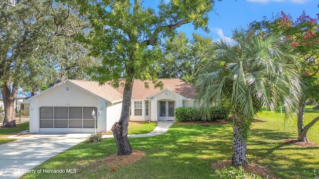 view of front of property with a garage and a front yard