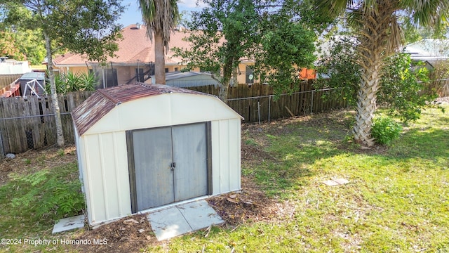 view of outbuilding featuring a lawn