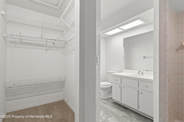 bathroom with vanity, toilet, and walk in shower