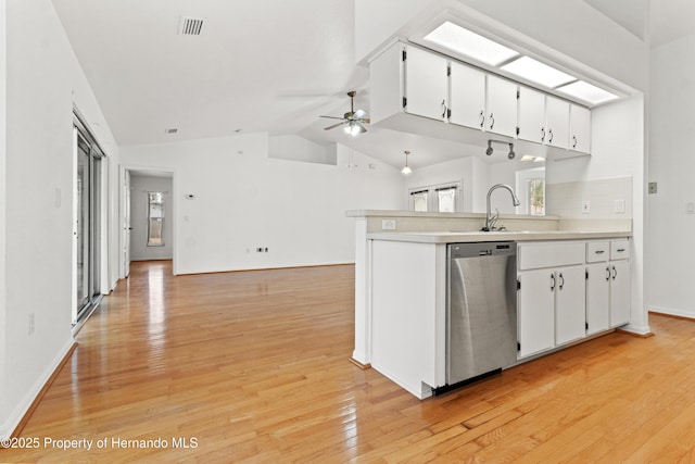 kitchen with dishwasher, a wealth of natural light, white cabinets, and ceiling fan