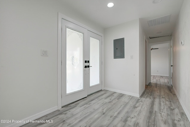 entrance foyer featuring electric panel, french doors, and light hardwood / wood-style flooring