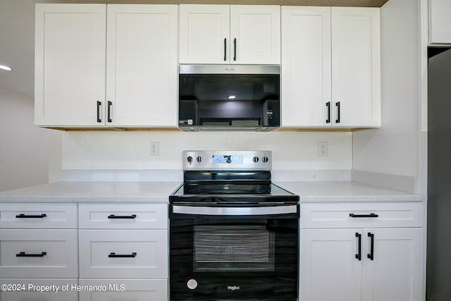 kitchen featuring white cabinets and appliances with stainless steel finishes