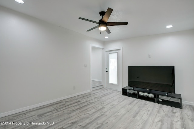 living room with light wood-type flooring and ceiling fan