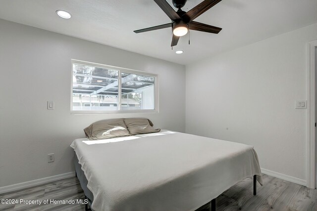 bedroom featuring light hardwood / wood-style floors and ceiling fan