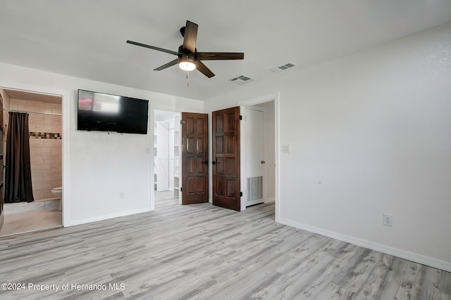 unfurnished bedroom featuring ceiling fan, connected bathroom, and light hardwood / wood-style flooring