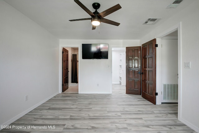 spare room with light wood-type flooring and ceiling fan