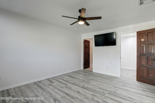 spare room featuring ceiling fan and light wood-type flooring