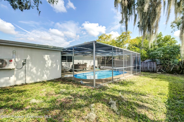 view of pool featuring a lanai, a yard, and ac unit