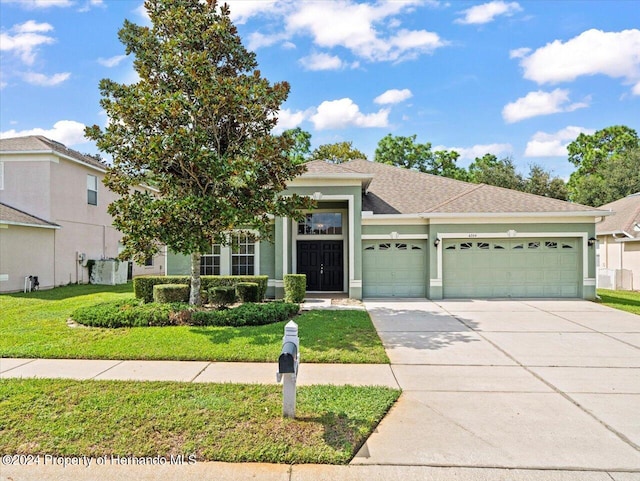 view of front facade with a garage and a front yard